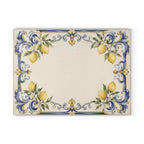 Elegant Italian glass charcuterie board styled on white marble counter with wine and fresh lemons