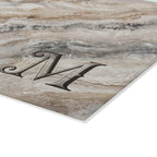 Closeup of monogram letter on marble glass serving board, permanently fired on tempered glass