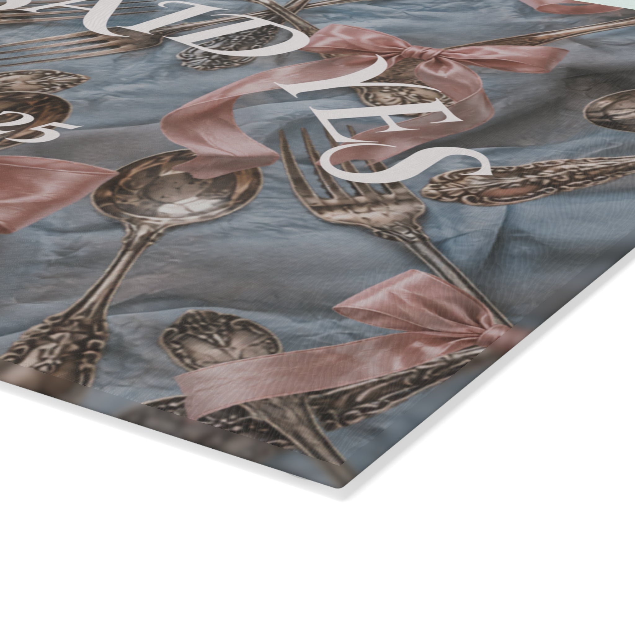 Closeup of vintage silver and blush bridal artwork permanently fired on glass serving board
